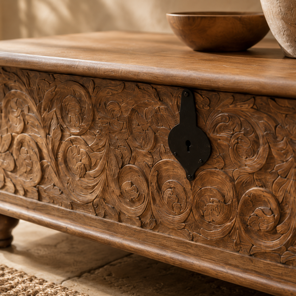 Close-up of hand-carved acanthus leaf scrollwork on mango wood trunk side panel