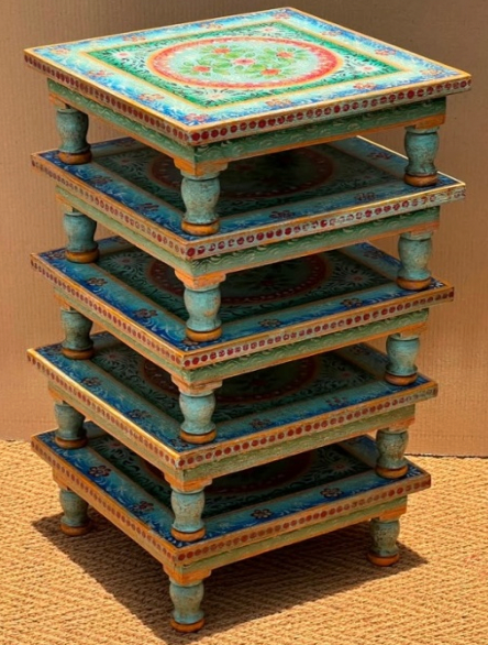 Hand-painted teal Bajot Chowki low tables stacked showing painted floral medallion top