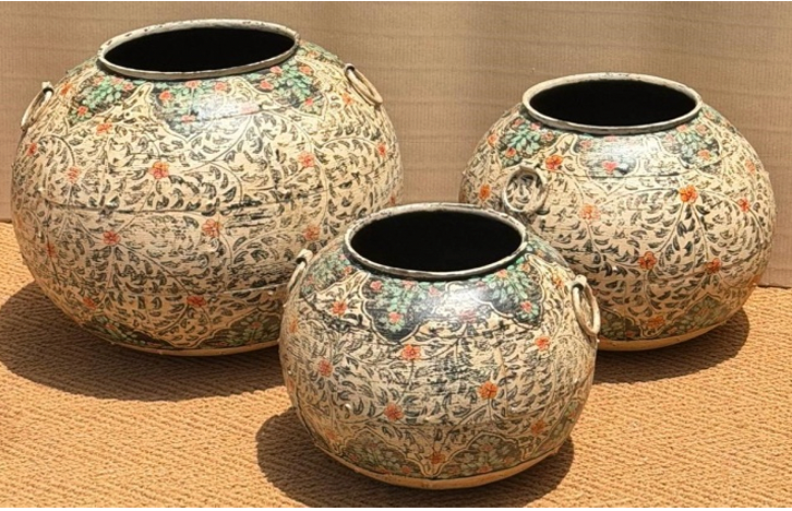Set of three graduated hand-painted Rajasthani metal pots in off-white with dense all-over scrolling sage green vine, sparse dusty pink flowers and iron ring handles