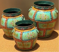 Set of three graduated hand-painted Rajasthani metal pots with mint celadon-green floral panel body, coral-red and gold panel borders, dark teal collar rim and teal loop handles