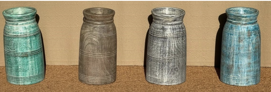 Set of four turned mango wood vases in tall cylindrical milk-bottle form with distressed colour-wash finishes: antique teal-green, warm grey-brown, cool silver-grey and dusty slate-blue, two incised ring grooves on each
