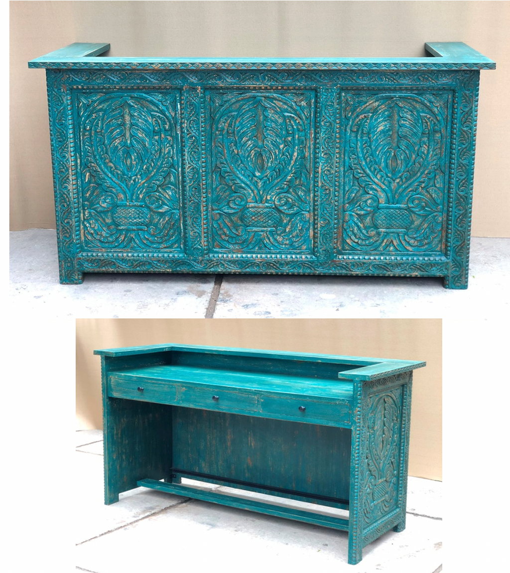 Hand-carved mango wood reception desk and counter in distressed teal turquoise with three large palmette acanthus carved panels on front face, flat overhanging top and rear working face with drawer and open shelf