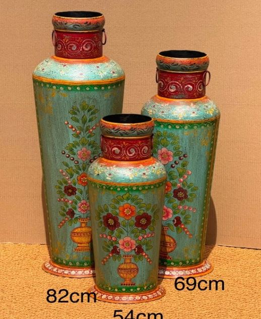 Set of three hand-painted metal floor vases in teal sage green with terracotta-red neck collars, embossed scrolling vine, iron ring handles and large central floral bouquet painting — sizes 82 cm, 69 cm and 54 cm
