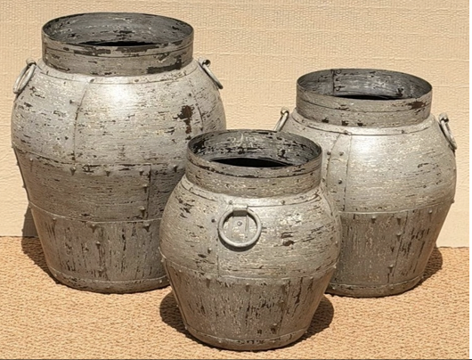 Set of three distressed iron pots in heavily cracked and chipped silver-grey chalky finish with horizontal ribbing, central iron ring pull and wide open rim