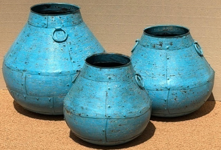 Set of three distressed iron onion pots in mid sky-blue with riveted panel seams, low squat wide-shouldered form with short neck and single iron ring handles on each side