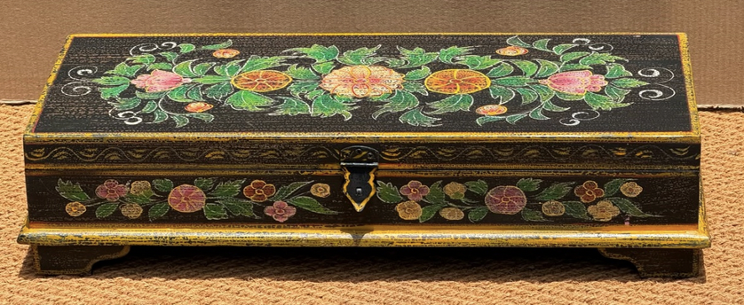 Hand-painted mango wood keepsake box in jet black with gold border banding, dense medallion floral lid with orange yellow peony, pink roses and dark green acanthus foliage, iron clasp and four bracket feet