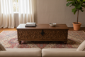 Hand-carved mango wood storage trunk – front hero as coffee table in warm living room