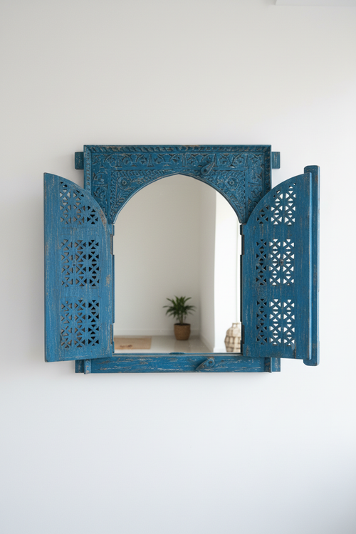 Antique cobalt blue jali window mirror – doors open in bright entryway