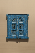 Antique cobalt blue jali window mirror – doors closed on neutral plaster wall