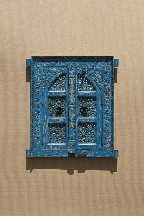 Antique cobalt blue jali window mirror – doors closed on neutral plaster wall