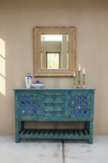 Hand-carved deep teal sideboard with tile inlays and iron ring pulls – front hero in dining room