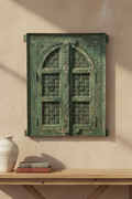 Antique sage green jali wall panel – hung above console table on neutral plaster wall