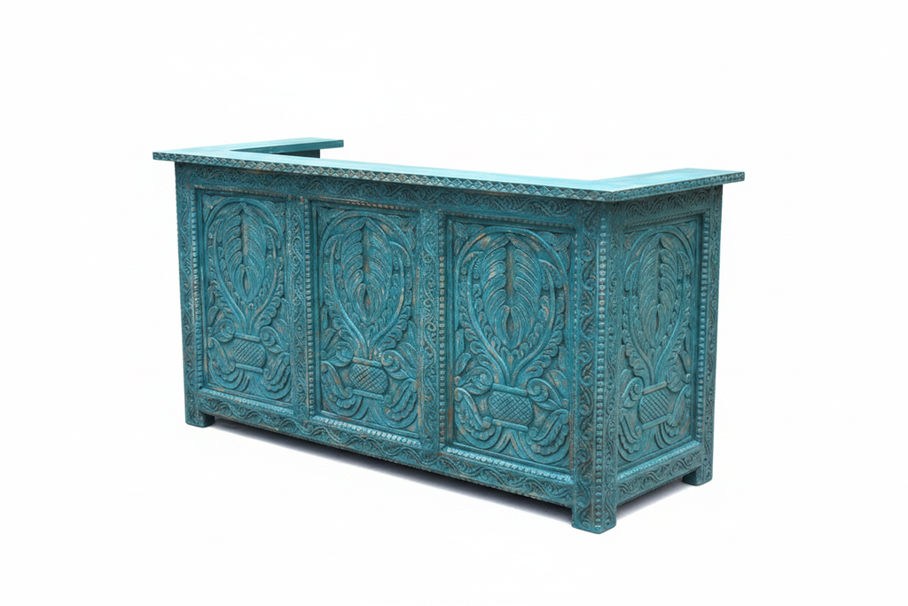 Distressed teal reception desk 3/4 angle showing front and carved side panel on white background