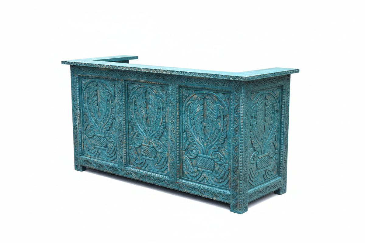 Distressed teal reception desk 3/4 angle showing front and carved side panel on white background