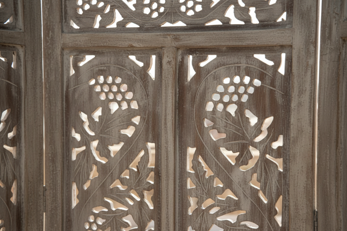 Close-up of hand-carved open floral vine jali with flowers, grapes and scrolling vines